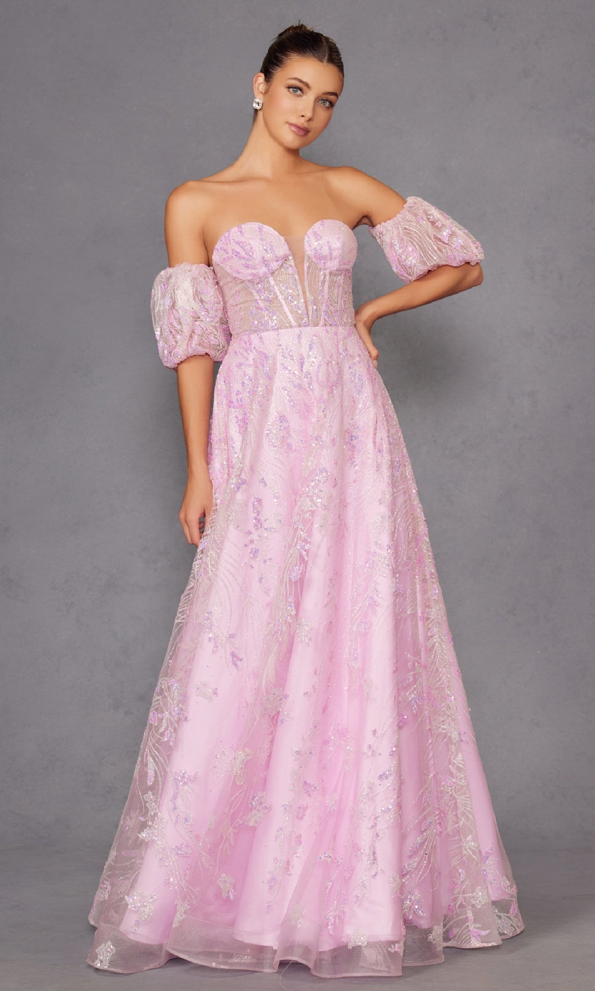 Woman in the Puff-Sleeve Strapless Long Glitter Prom Dress 2404, featuring a sheer bodice and puff sleeves, stands against a plain gray background.